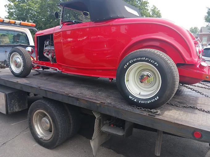 A classic hot rod loaded and secured on the flatbed